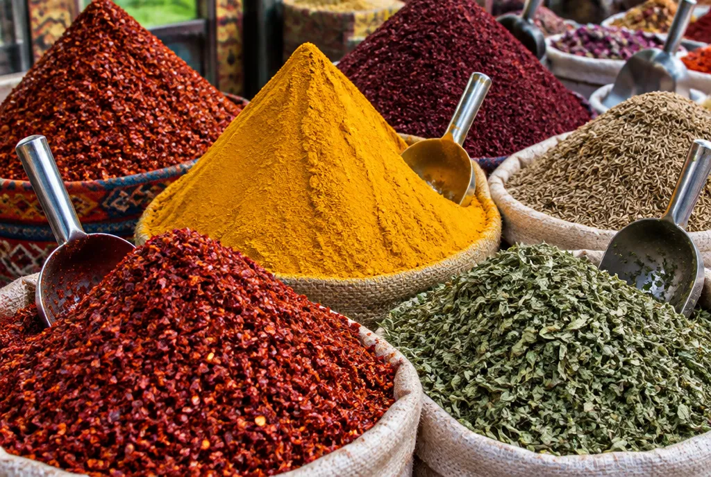 Mounds of red pepper, turmeric, sumac and dried mint at a spice stall